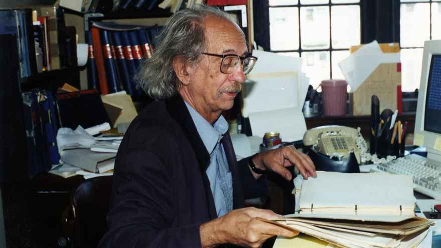 Miguel Civil, an expert on ancient Sumerians, examines documents in the Oriental Institute.