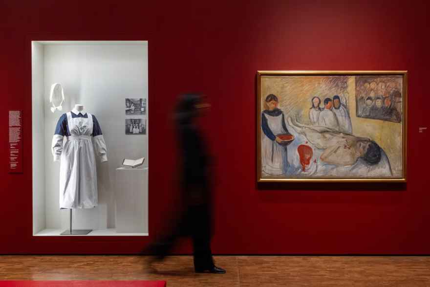 Blurry figure walking between two paintings
