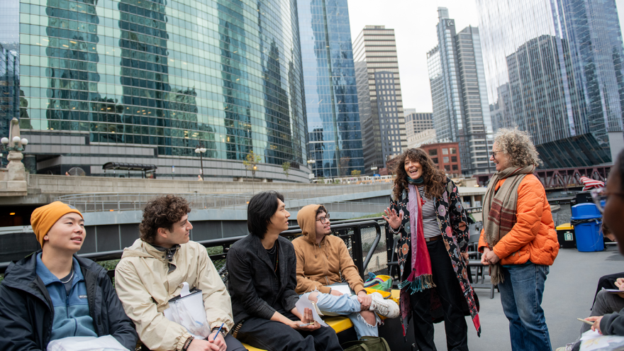 UChicago scholars Amber Ginsburg (right) and Jennifer Scappettone (second from right) discuss the history of the Chicago River during a class trip on a water taxi. Photo by Jean Lachat UChicago scholars Amber Ginsburg (right) and Jennifer Scappettone (second from right) discuss the history of the Chicago River during a class trip on a water taxi. Photo by Jean Lachat