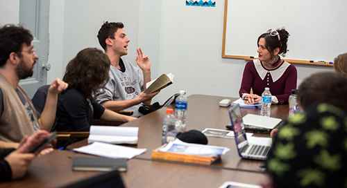 Lecturer Rachel DeWoskin (right) leads students in a fiction writing course at Taft House.